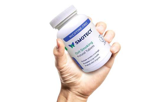 Holding a smotect Natural Tablets Bottle in hand