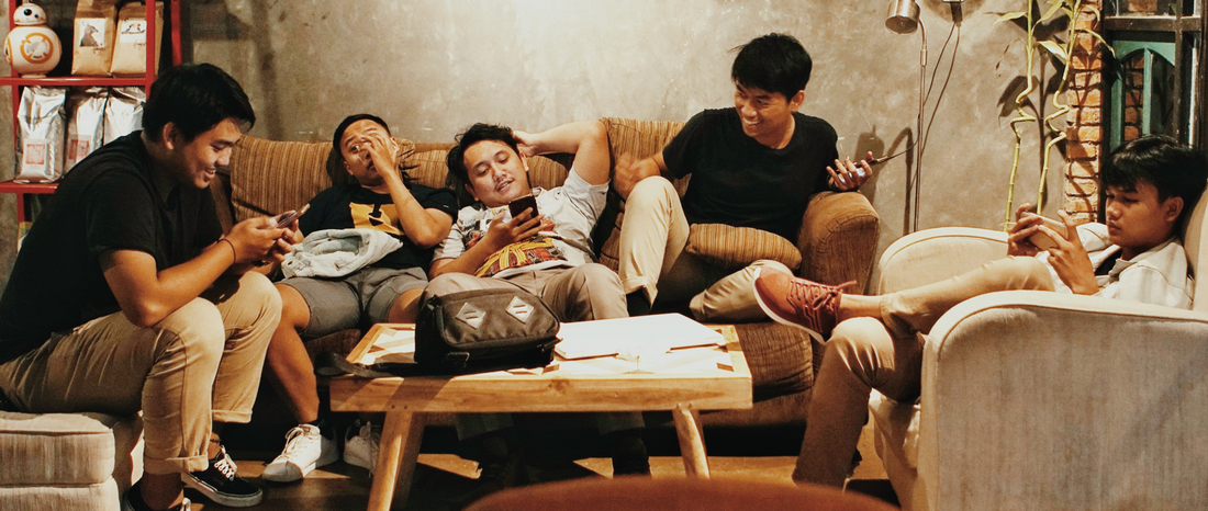 A group of people chilling in a room 