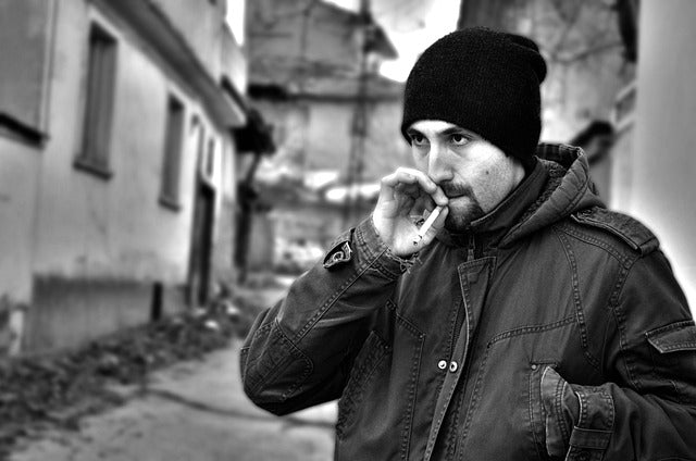 A man smoking a cigarette in winter season